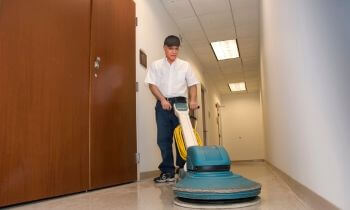 Cleaner polishing the floor of a commercial building in Ballwin, MO